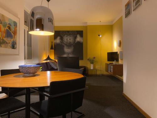 a dining room with a table and chairs in a room at Besselaar Apartments in Maastricht