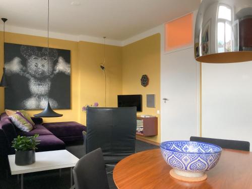 a living room with a bowl on a table at Besselaar Apartments in Maastricht