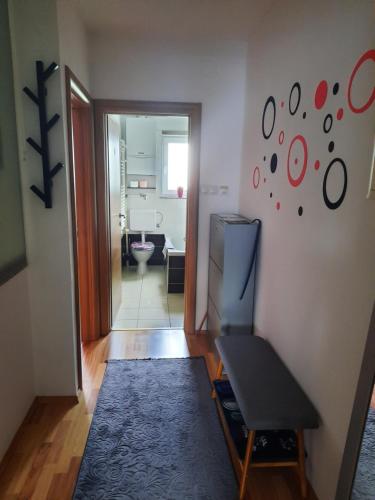 a living room with a television and a room with a bathroom at Apartman Trio Maksimir in Zagreb
