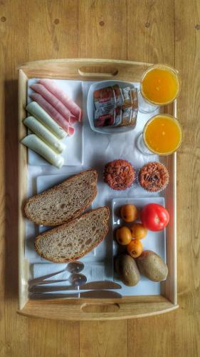 a lunch box with different types of food in it at La Figal de Xugabolos, Salas in Salas