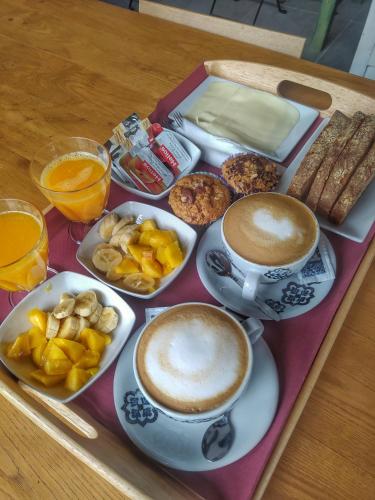 a tray with cups of coffee and plates of food at La Figal de Xugabolos, Salas in Salas