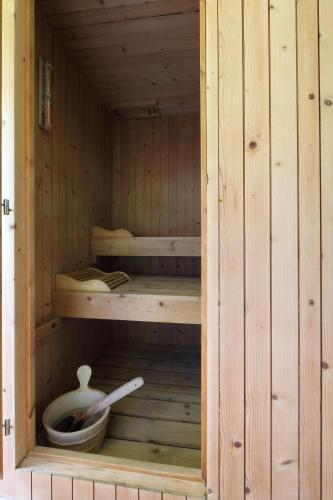 a wooden sauna with a bowl and a spoon at Sky Garden & Wellness R. in Belluno