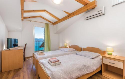 a bedroom with a large bed and a television at Apartments Franelli in Brseč