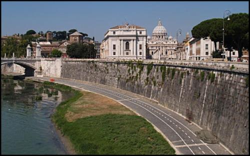 a bridge over a river with buildings in the background at My Bed Vatican Museum in Rome