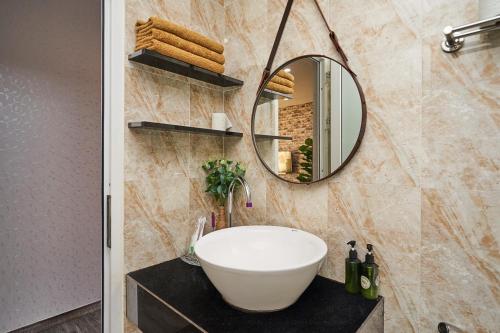 a bathroom with a sink and a mirror at Smile Apartment in Ha Long