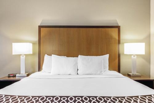 a bedroom with a large bed with two lamps at La Quinta by Wyndham Biloxi in Biloxi