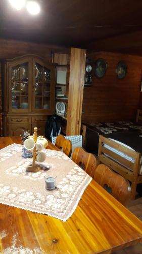 a dining room table with a table cloth on it at Apartmán u potoka in Sadov