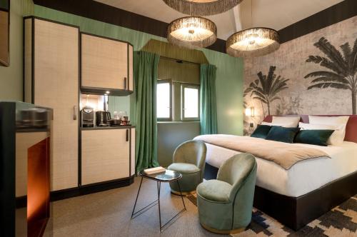 a bedroom with a bed and a table and chairs at MiHotel Tour Rose in Lyon