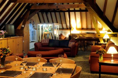 a living room with a table with wine glasses on it at Brackenborough Hall Coach House - Granary in Louth