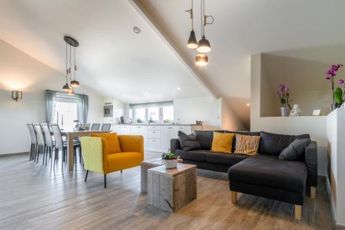 a living room with a couch and a table at Bed en Vrijheid in Peer