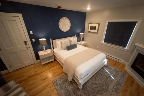 a bedroom with a large white bed and a window at Serenity Inn Newport in Newport