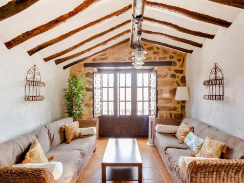 a living room with two couches and a table at Attractive Villa in Montefrio with Private Pool in Montefrío