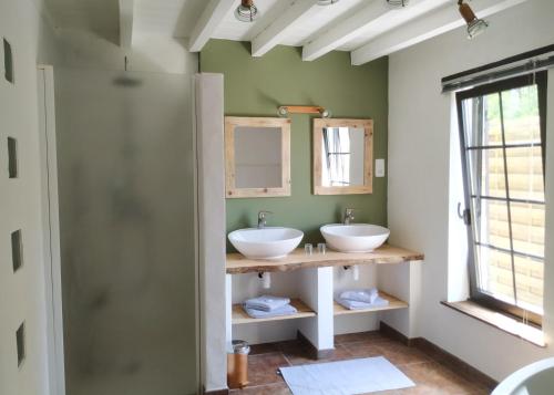 a bathroom with two sinks and a window at La résiniere de pirique in Parentis-en-Born