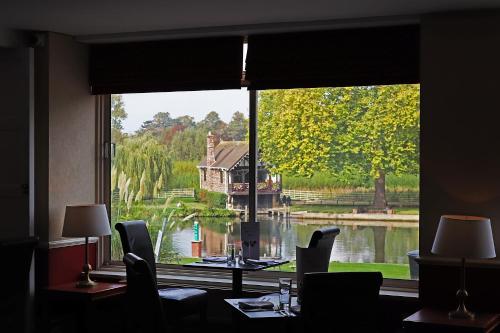 a living room filled with furniture and a window at Shillingford Bridge Hotel in Wallingford
