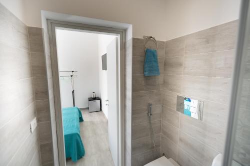 a bathroom with a walk in shower and a glass door at Venti di Brucoli in Brucoli