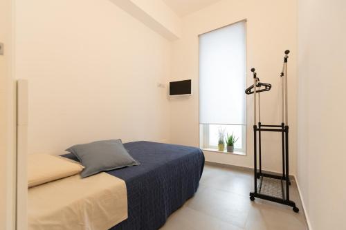 a bedroom with a bed and a window at Venti di Brucoli in Brucoli