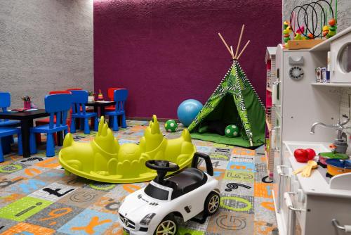 a childs play room with a toy car and a tent at STELLA Resort & SPA in Władysławowo