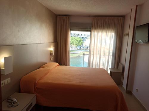 a hotel room with a bed and a window at Hotel Marina in Peniscola