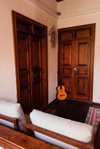 a living room with a guitar and a couch at Lily Town Hotel in Antalya