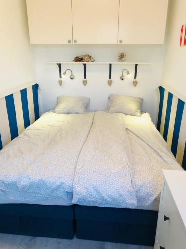 a bedroom with a large bed in a room at Piano Balaton Apartment in Zamárdi