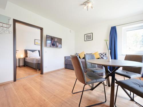 a living room with a table and a couch at Apartments at Winterhafen in Linz