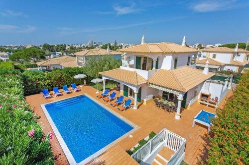 an aerial view of a house with a swimming pool at Villa White Sands - Private Oasis, Heated Pool, Beaches & Strip Nearby in Albufeira