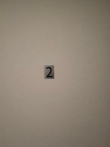 a clock on a wall with the number two on it at Apartmani Bella Vista in Njivice