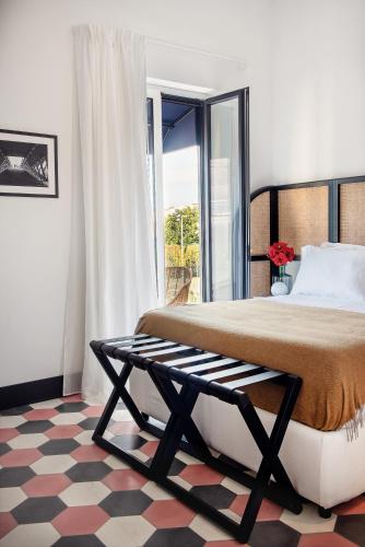 a bedroom with a large bed and a window at Magnolia Boutique Rooms in Catania