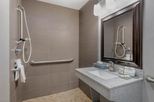 a bathroom with a sink and a shower at La Quinta Inn & Suites by Wyndham Fort Worth Arlington West in Arlington