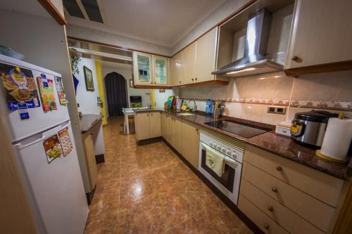 a kitchen with a sink and a refrigerator at Casa Pueblo Alzira No Compartida in Alzira