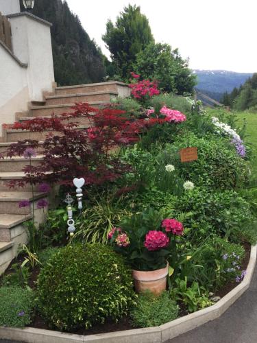 a garden of flowers and plants next to steps at Alpenapart Walch in Jerzens