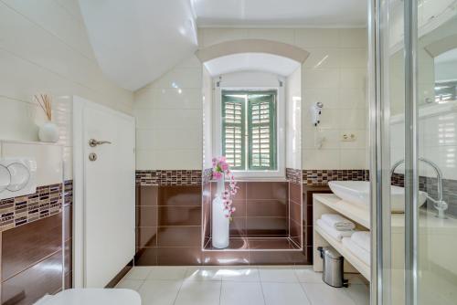 a bathroom with a shower and a sink and a toilet at Guesthouse Imperator in Split