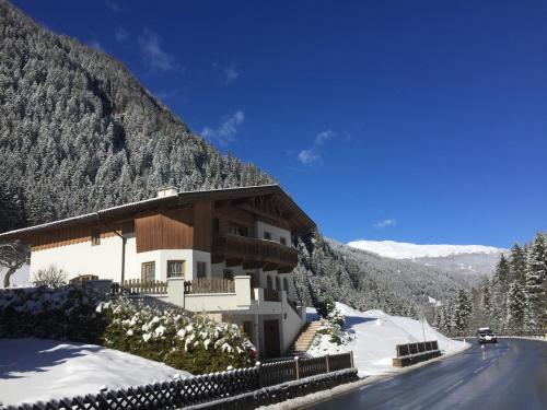 a building on the side of a snow covered mountain at Alpenapart Walch in Jerzens