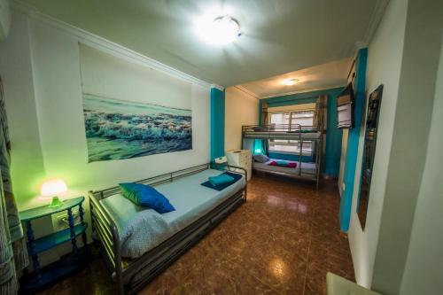 a bedroom with a bed with a painting on the wall at Casa Pueblo Alzira No Compartida in Alzira