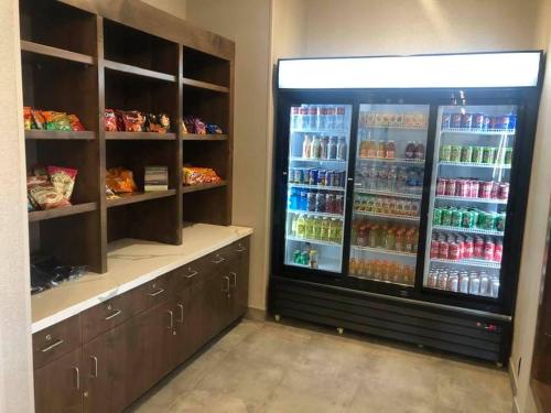 a store with a large refrigerator filled with drinks at La Quinta Inn & Suites Limon by Wyndham in Limon