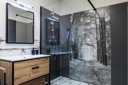 a bathroom with a shower with a forest mural at Chalets Royal, Tatranská Lomnica in Tatranská Lomnica
