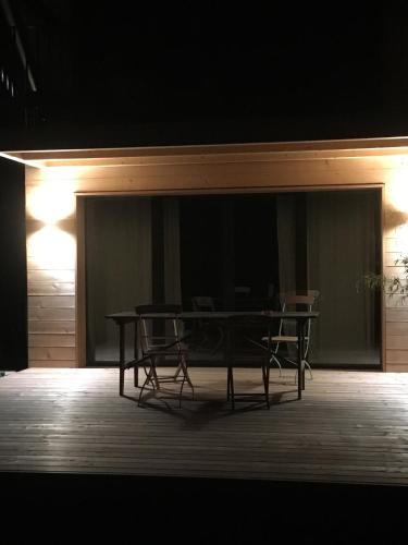 a table and chairs on a stage with lights at A Côté in Oron-la-ville