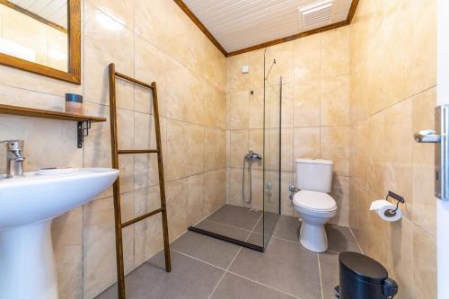 a bathroom with a shower and a toilet and a sink at Bhavana Gökova in Akyaka