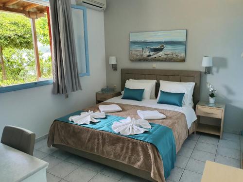 a bedroom with a bed with towels on it at Daglas Beach House in Nydri