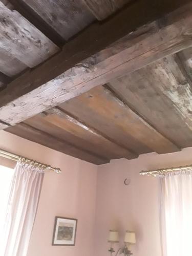 a room with wooden ceilings and white curtains at Hotel Feiler in Muggendorf