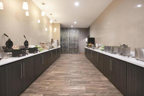a large kitchen with a long row of counters at La Quinta by Wyndham Amarillo Airport in Amarillo