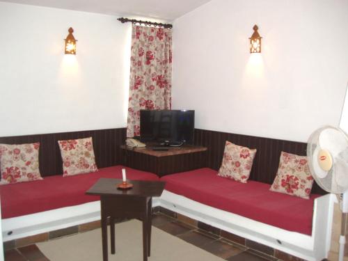 a living room with two couches and a tv at Apartamentos Turisticos Marsol in Lagos