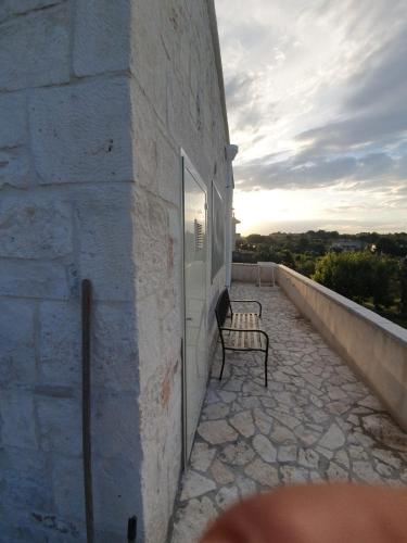 a bench sitting on the side of a building at Trullo Le Tre Sorelle in Cisternino
