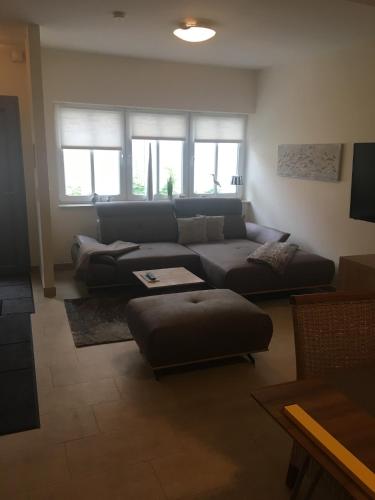 a living room with a couch and a table at Fewo31, exklusive Apartments, 2 Minuten vom Strand und Alten Strom in Warnemünde