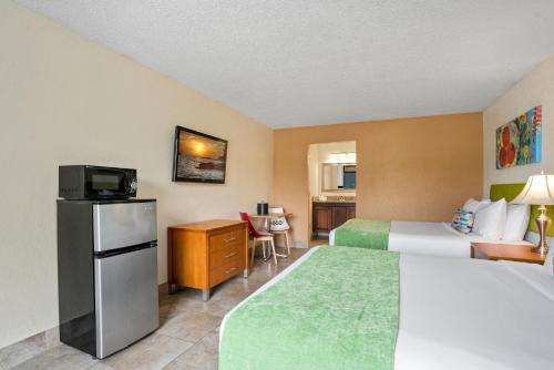 a hotel room with a bed and a television at Park Royal Orlando in Kissimmee