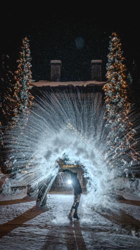 a man is standing in front of a fountain at Blackcomb Springs Suites by CLIQUE in Whistler