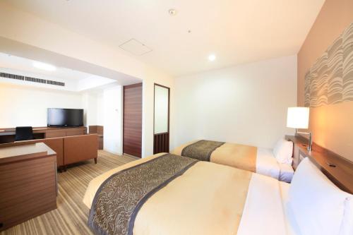Ένα ή περισσότερα κρεβάτια σε δωμάτιο στο Vessel Inn Sapporo Nakajima Park