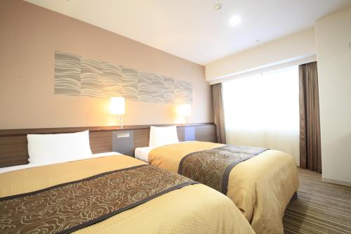 Ένα ή περισσότερα κρεβάτια σε δωμάτιο στο Vessel Inn Sapporo Nakajima Park