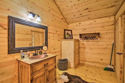 a bathroom with a sink in a log cabin at Rustic-Chic Country Cabin - 10 Mi to Main Street! in Fredericksburg
