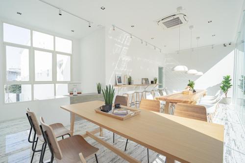 a dining room with wooden tables and chairs at Any Day House Chiang mai in Chiang Mai